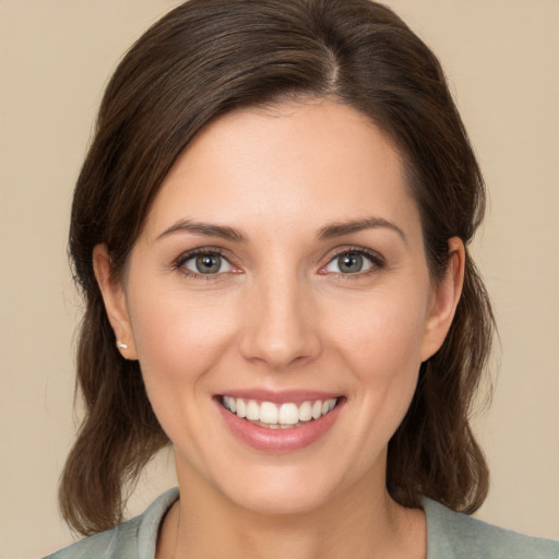 Joyful white young-adult female with medium  brown hair and brown eyes