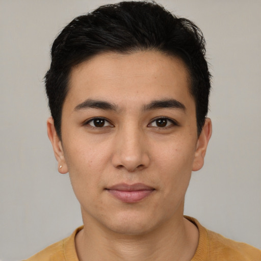 Joyful latino young-adult male with short  black hair and brown eyes