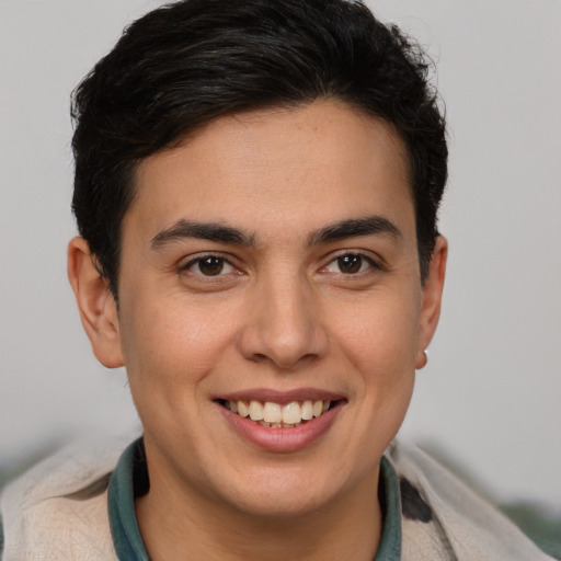 Joyful latino young-adult male with short  brown hair and brown eyes