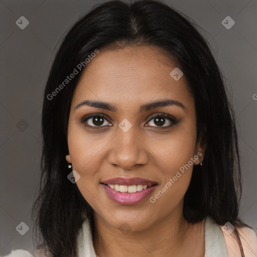 Joyful black young-adult female with long  brown hair and brown eyes