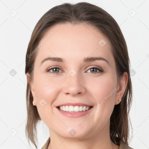 Joyful white young-adult female with medium  brown hair and grey eyes