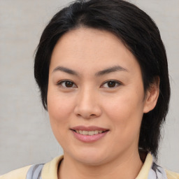 Joyful asian young-adult female with medium  brown hair and brown eyes