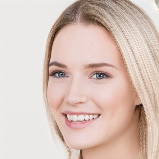 Joyful white young-adult female with long  brown hair and blue eyes