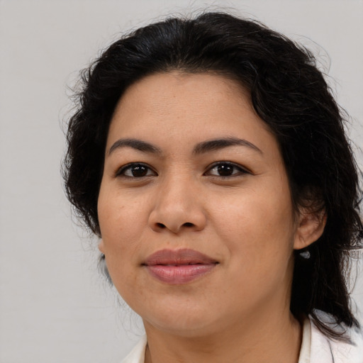 Joyful latino adult female with medium  brown hair and brown eyes
