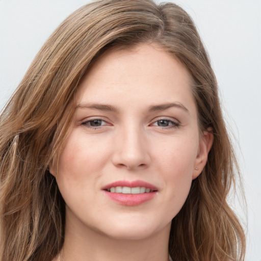 Joyful white young-adult female with long  brown hair and grey eyes