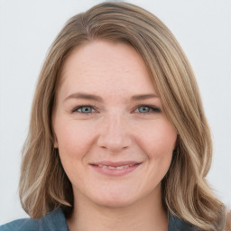 Joyful white young-adult female with medium  brown hair and blue eyes