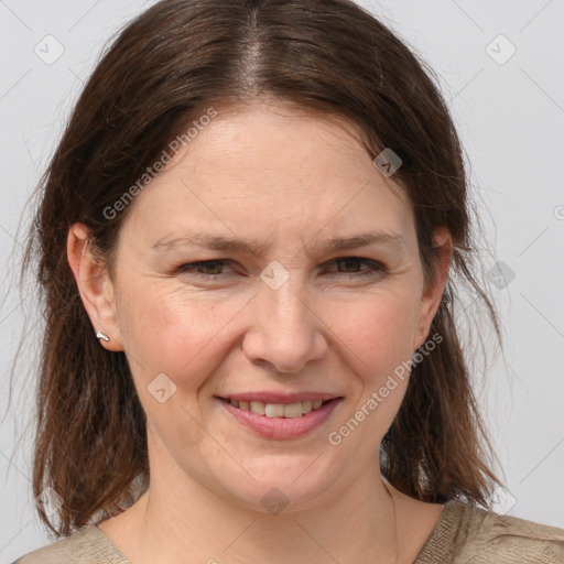 Joyful white adult female with medium  brown hair and brown eyes