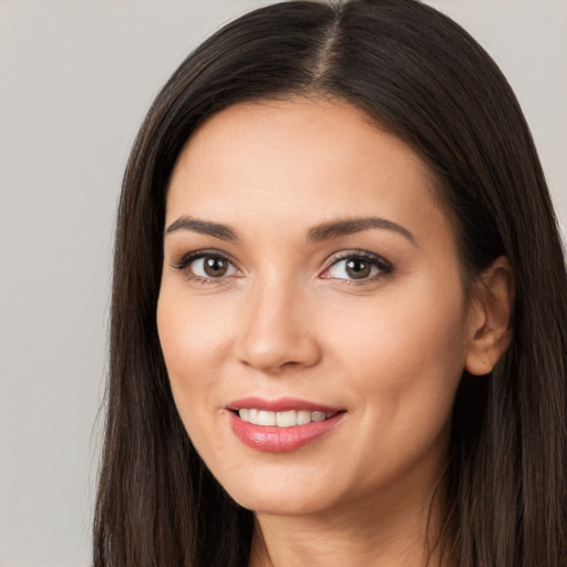 Joyful white young-adult female with long  brown hair and brown eyes