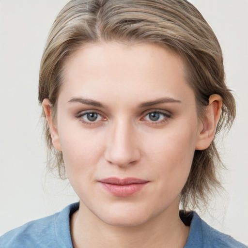 Joyful white young-adult female with medium  brown hair and blue eyes