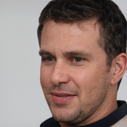 Joyful white adult male with short  brown hair and brown eyes