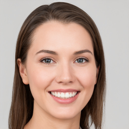 Joyful white young-adult female with long  brown hair and grey eyes