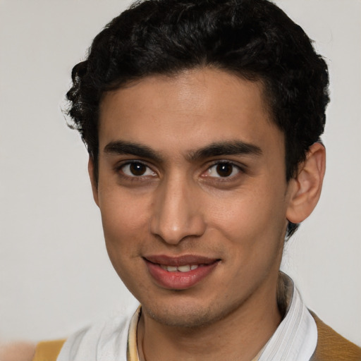 Joyful latino young-adult male with short  black hair and brown eyes