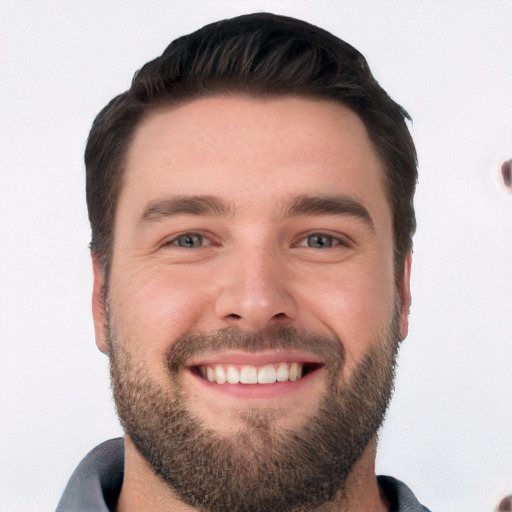 Joyful white young-adult male with short  black hair and brown eyes