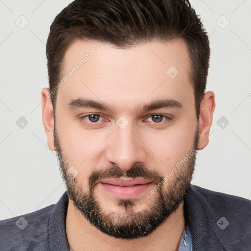 Joyful white young-adult male with short  brown hair and brown eyes