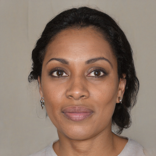 Joyful black young-adult female with medium  brown hair and brown eyes