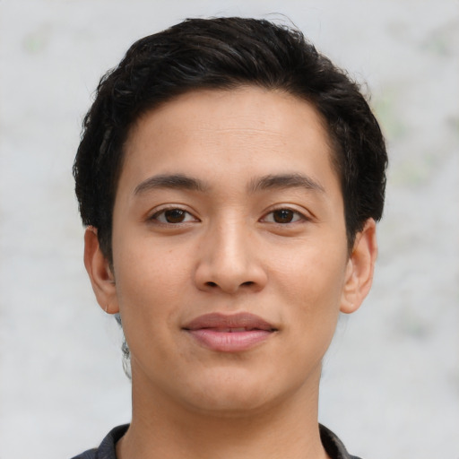 Joyful asian young-adult male with short  brown hair and brown eyes