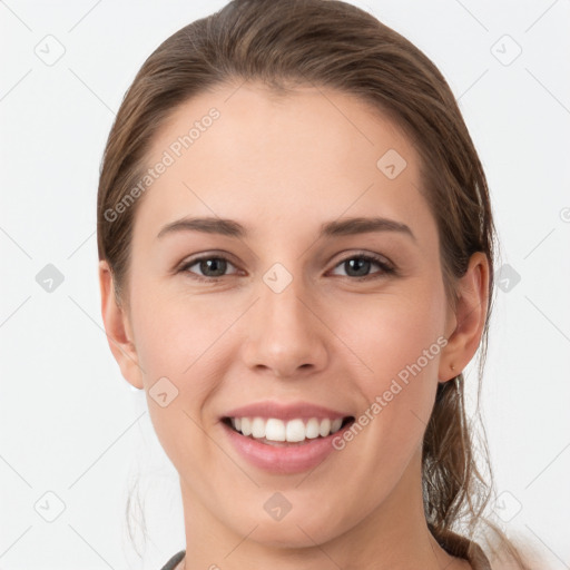 Joyful white young-adult female with medium  brown hair and grey eyes