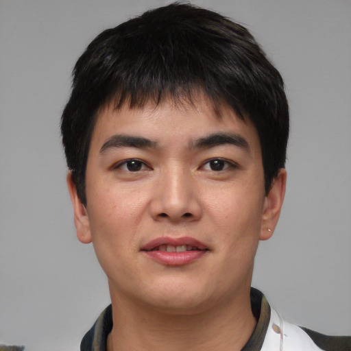 Joyful asian young-adult male with short  black hair and brown eyes