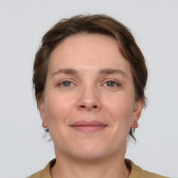 Joyful white adult female with short  brown hair and grey eyes