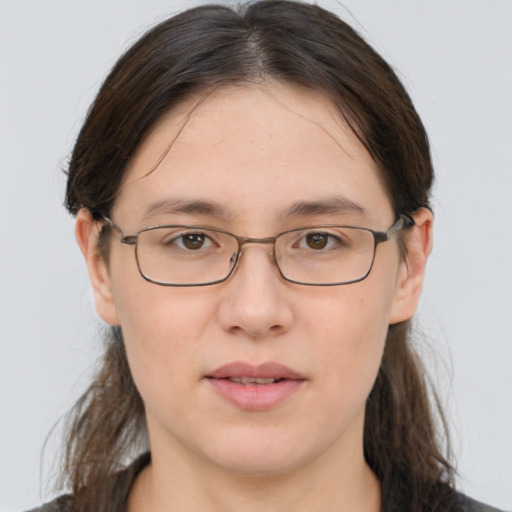 Joyful white young-adult female with medium  brown hair and grey eyes