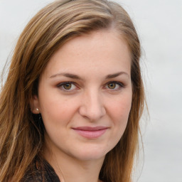 Joyful white young-adult female with long  brown hair and green eyes