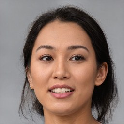 Joyful asian young-adult female with medium  brown hair and brown eyes