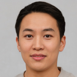 Joyful asian young-adult male with short  black hair and brown eyes