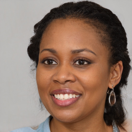 Joyful black young-adult female with medium  brown hair and brown eyes