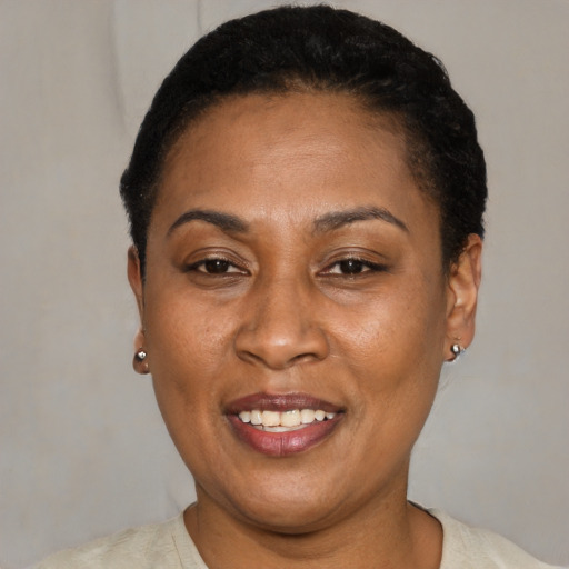 Joyful latino adult female with short  black hair and brown eyes