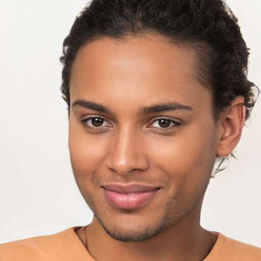 Joyful latino young-adult male with short  brown hair and brown eyes