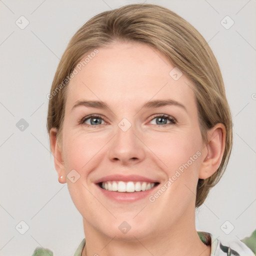 Joyful white young-adult female with medium  brown hair and green eyes