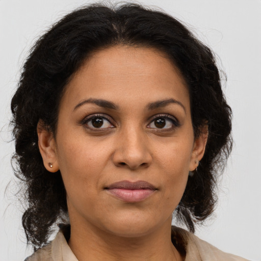 Joyful latino adult female with medium  brown hair and brown eyes