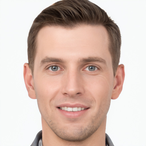 Joyful white young-adult male with short  brown hair and grey eyes