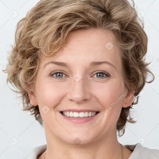 Joyful white young-adult female with medium  brown hair and blue eyes