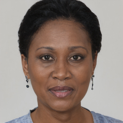Joyful black adult female with short  black hair and brown eyes