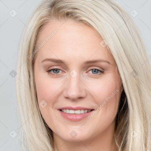 Joyful white young-adult female with long  brown hair and blue eyes