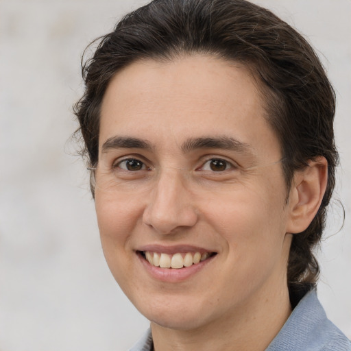 Joyful white adult female with medium  brown hair and brown eyes