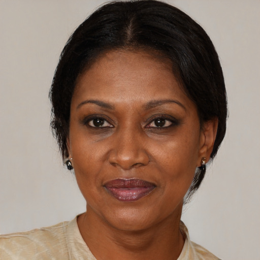 Joyful black adult female with medium  brown hair and brown eyes