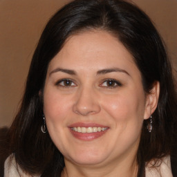 Joyful white adult female with long  brown hair and brown eyes