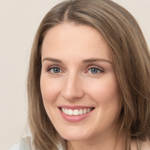 Joyful white young-adult female with long  brown hair and green eyes