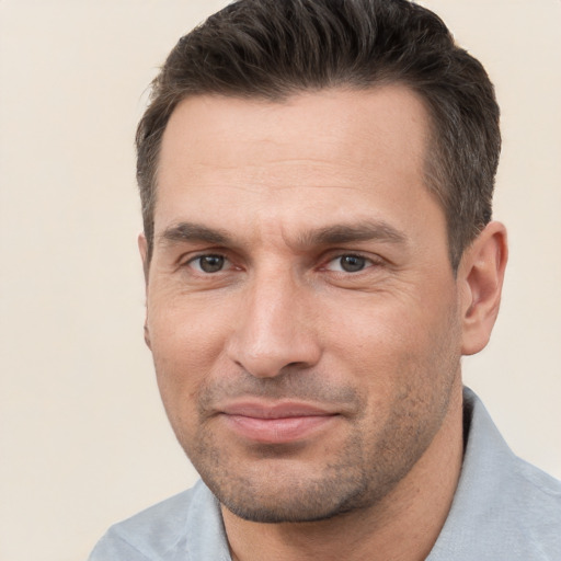 Joyful white adult male with short  brown hair and brown eyes