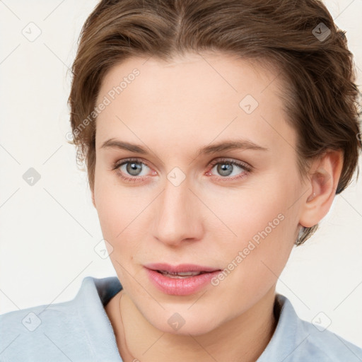 Joyful white young-adult female with short  brown hair and blue eyes