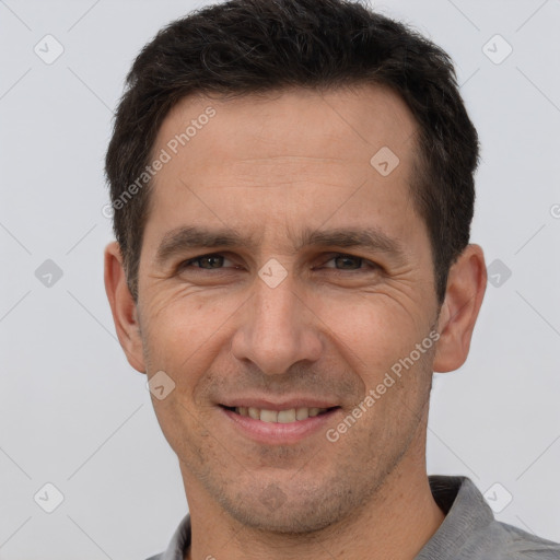 Joyful white adult male with short  brown hair and brown eyes