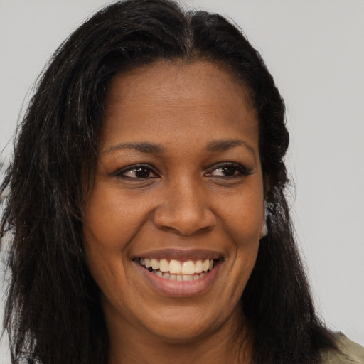 Joyful latino young-adult female with long  brown hair and brown eyes