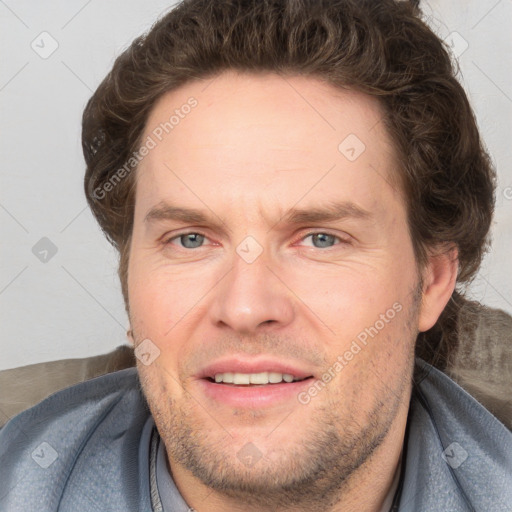 Joyful white adult male with short  brown hair and grey eyes