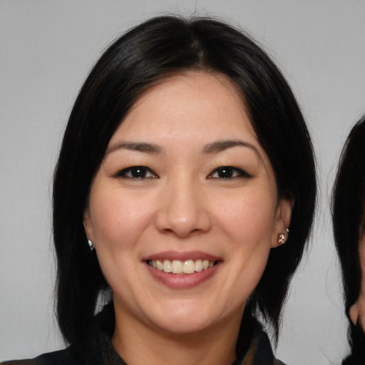 Joyful white young-adult female with long  black hair and brown eyes