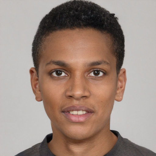 Joyful black young-adult male with short  brown hair and brown eyes