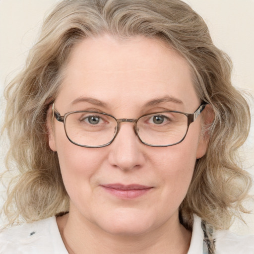 Joyful white adult female with medium  brown hair and blue eyes