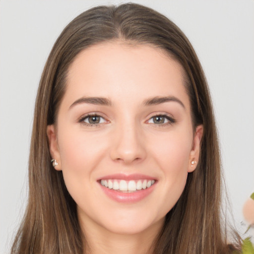 Joyful white young-adult female with long  brown hair and grey eyes