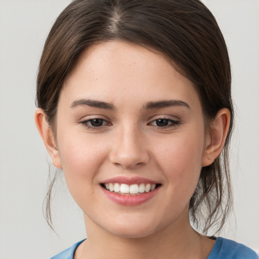 Joyful white young-adult female with medium  brown hair and grey eyes